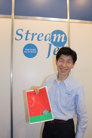Hiroshin Nakagawa with one of the printed textbooks